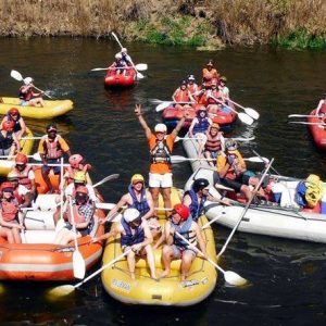 group on river rafts and crocs