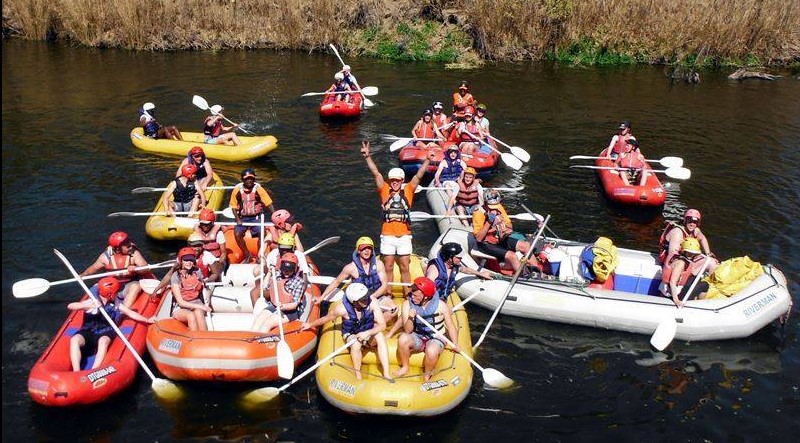 group on river rafts and crocs